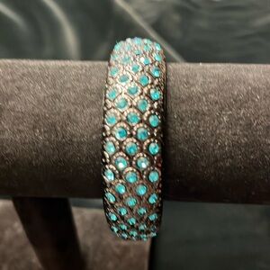 Peacock-inspired Brilliant Blue Crystals Encrusted In Black Textured Metal